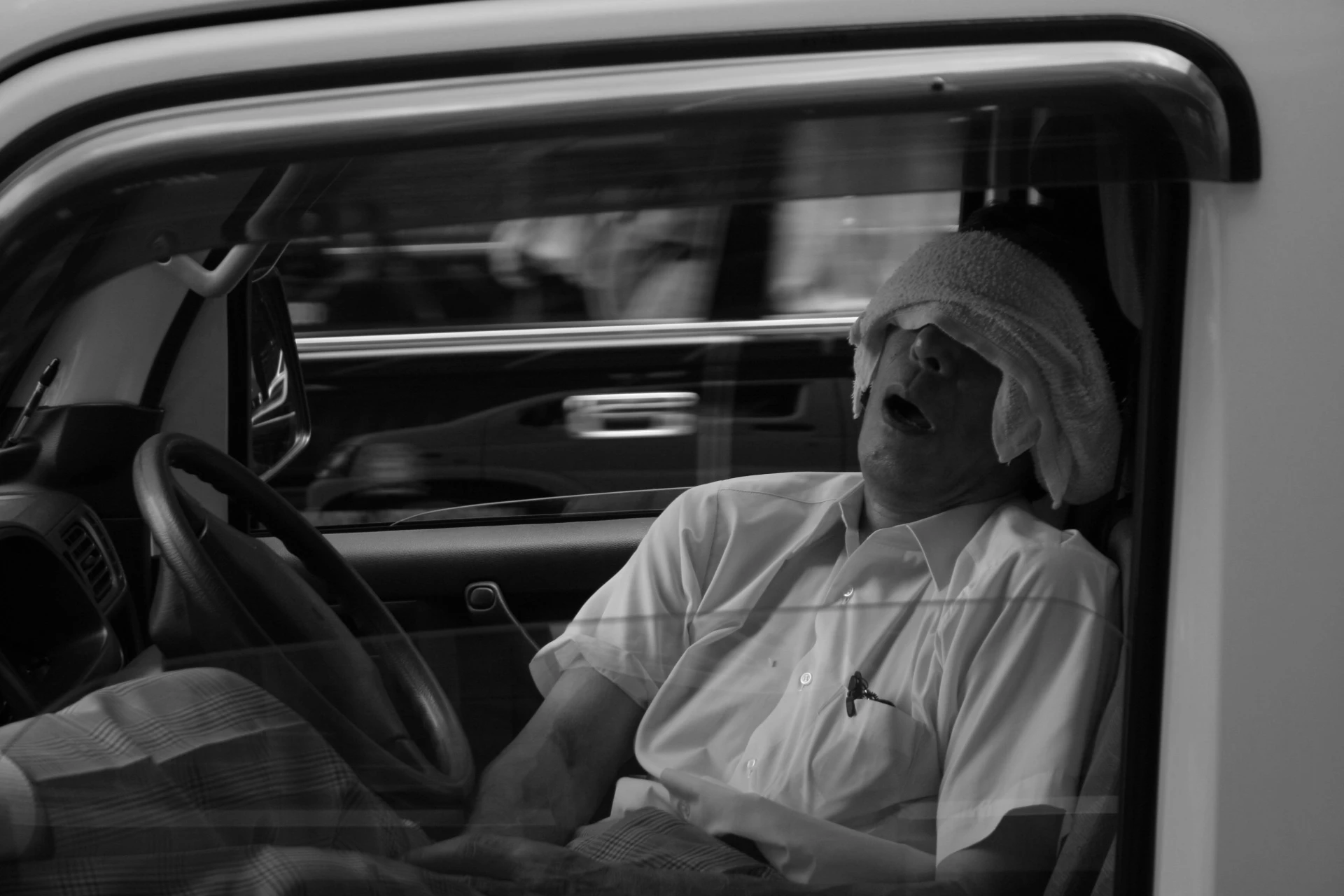 Driver asleep at the wheel, illustrating the danger of impairment from sleep deprivation